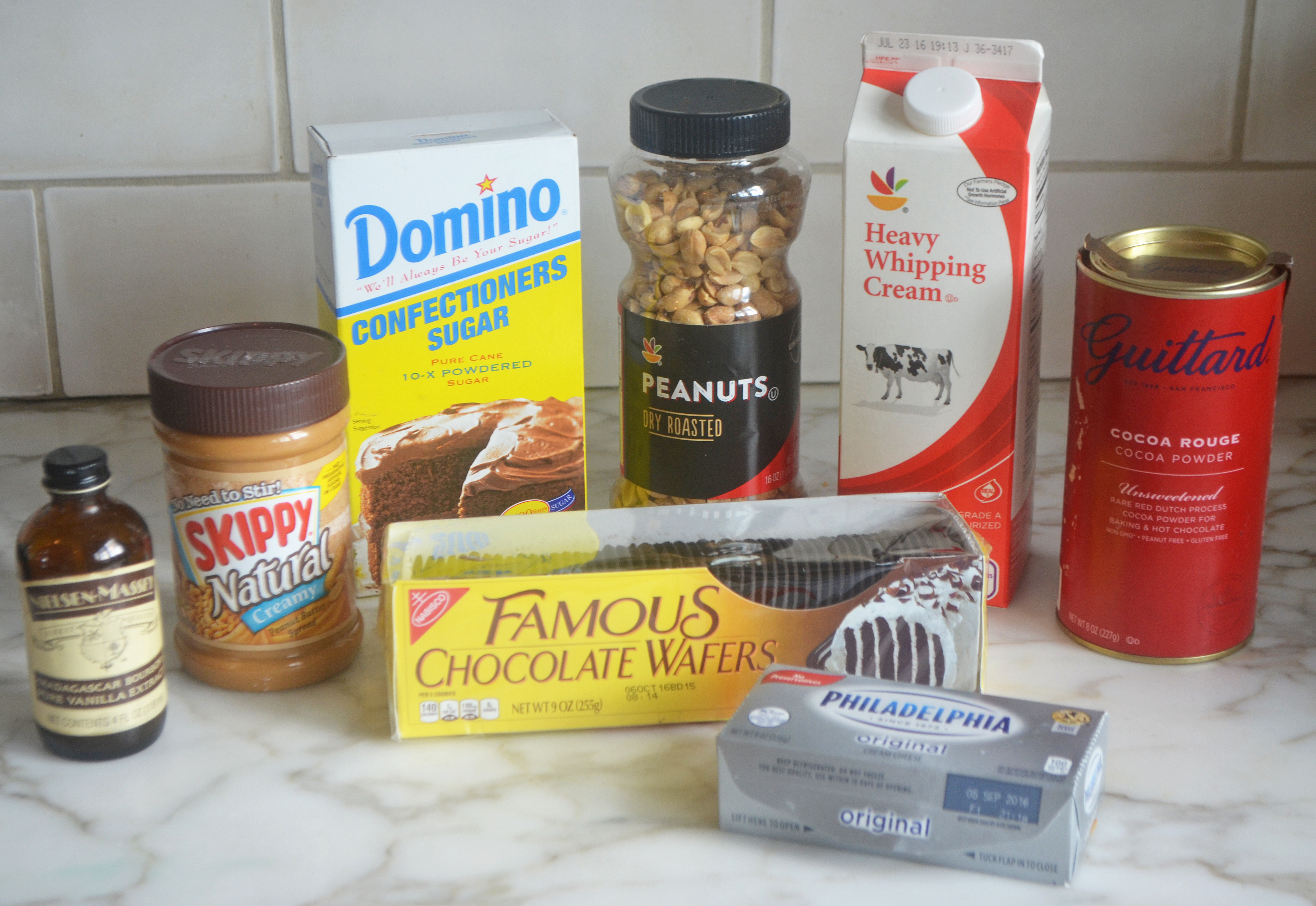 Cake ingredients including chocolate wafers, peanut butter, and peanuts.