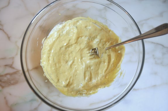 Fork in a bowl of mustard sauce.