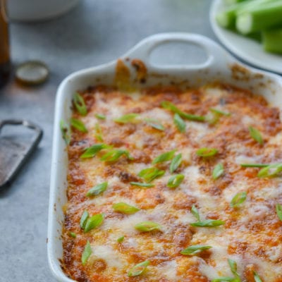 Buffalo chicken dip in a white baking dish.