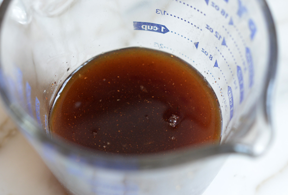 Dark liquid in a measuring cup.