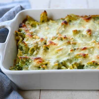 Penne with spinach, ricotta, and fontina in a baking dish.