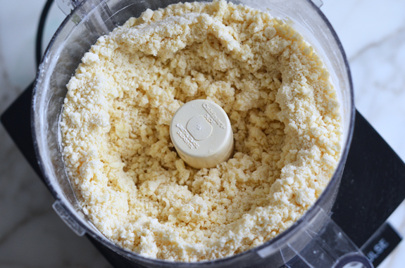 Crumbly mixture in a food processor.