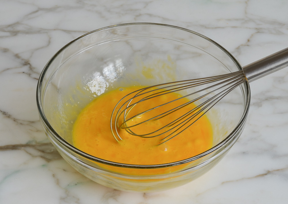 whisked eggs and egg yolks in mixing bowl