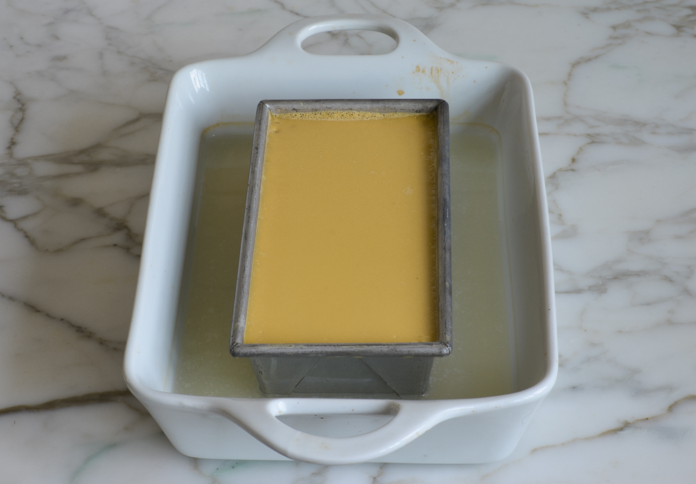 baked flan cooling in water bath