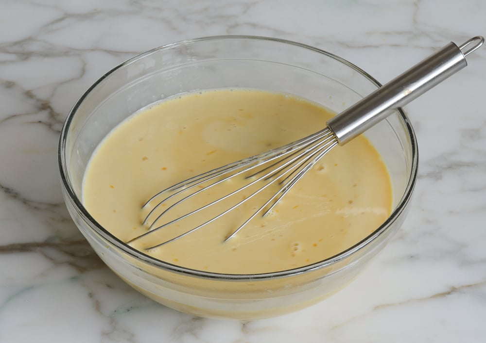 Whisked custard mixture in mixing bowl.