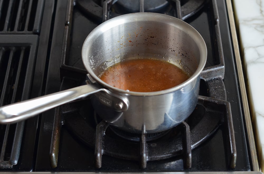 Sugar and water mixture turning to a caramel color.