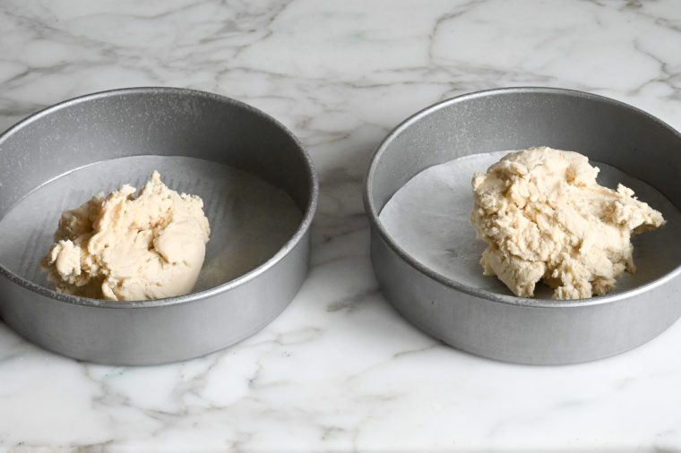 shortbread dough in cake pans