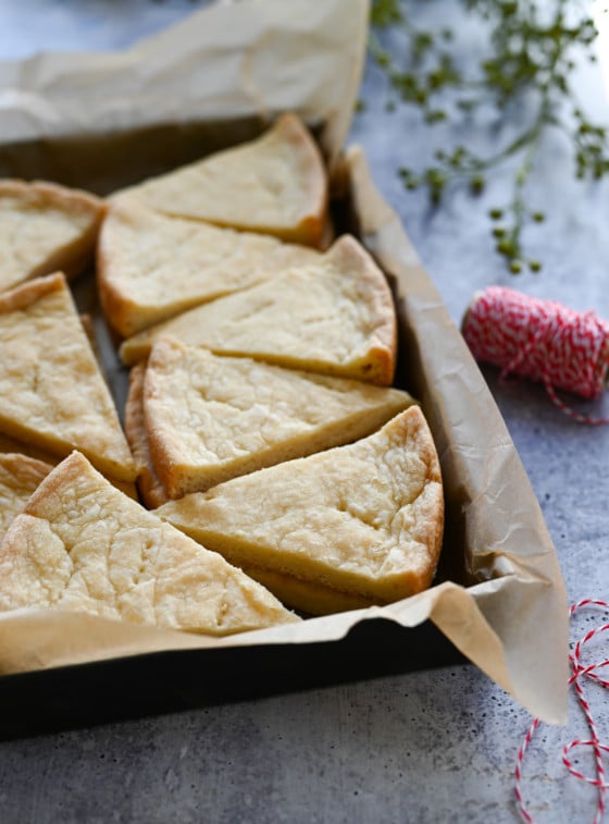 shortbread stacked in baking dish with Christmas ribbon.