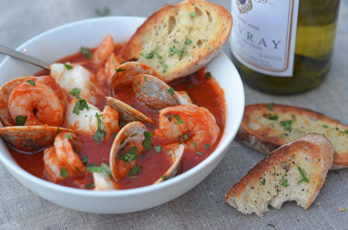 Cioppino ingredients including shrimp, butter, and crushed red pepper.