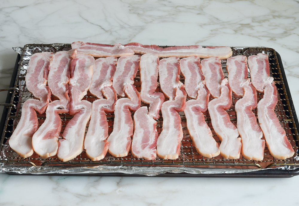 bacon arranged on rack and baking sheet