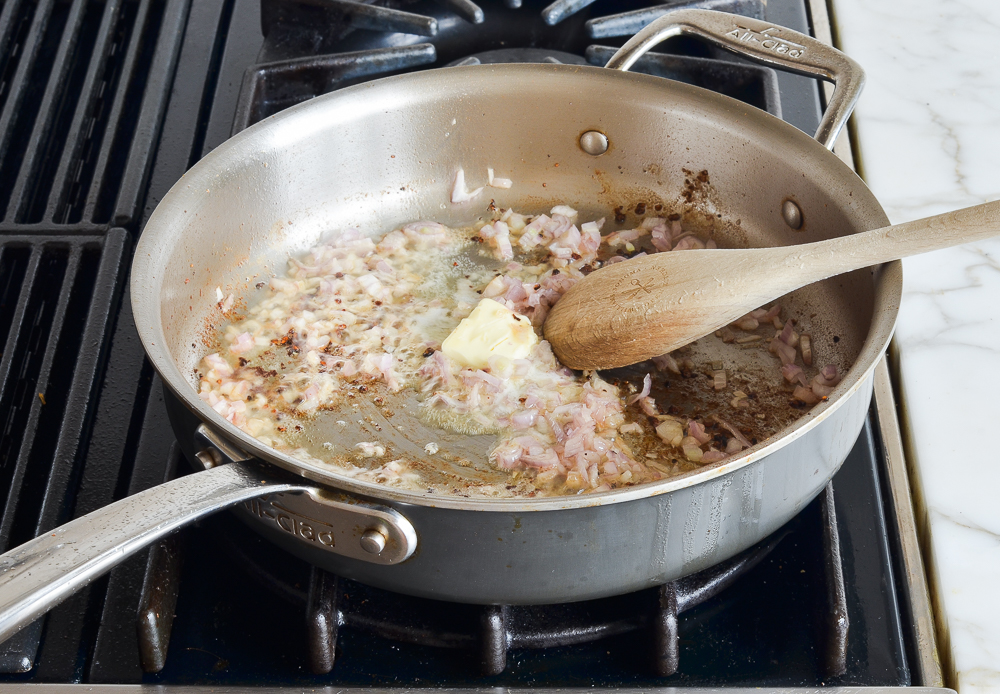 adding butter and shallots to the skillet