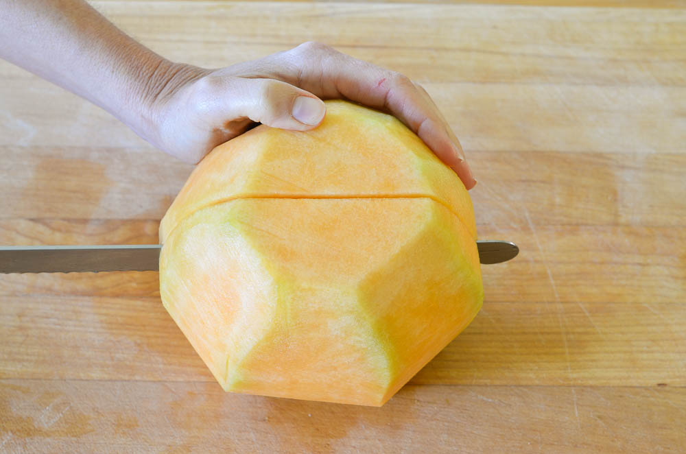 cutting through center of melon