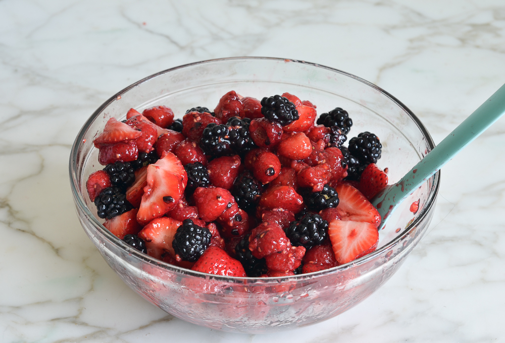 Spoon in a bowl of berries.