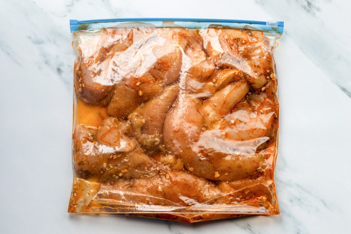 chicken marinating in zip-lock bag