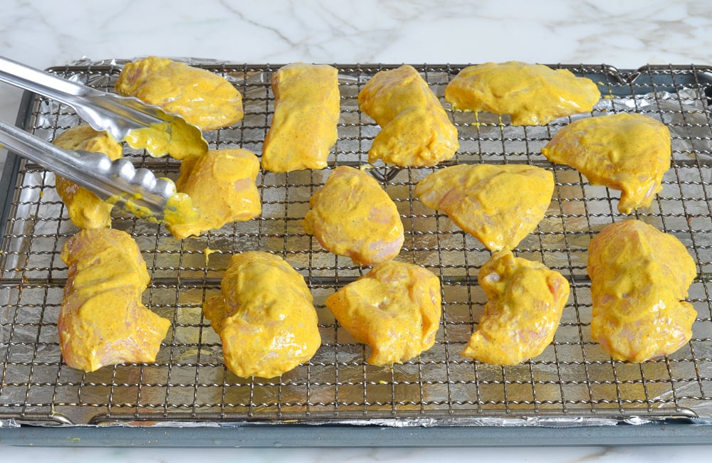 arranging chicken on cooking rack 