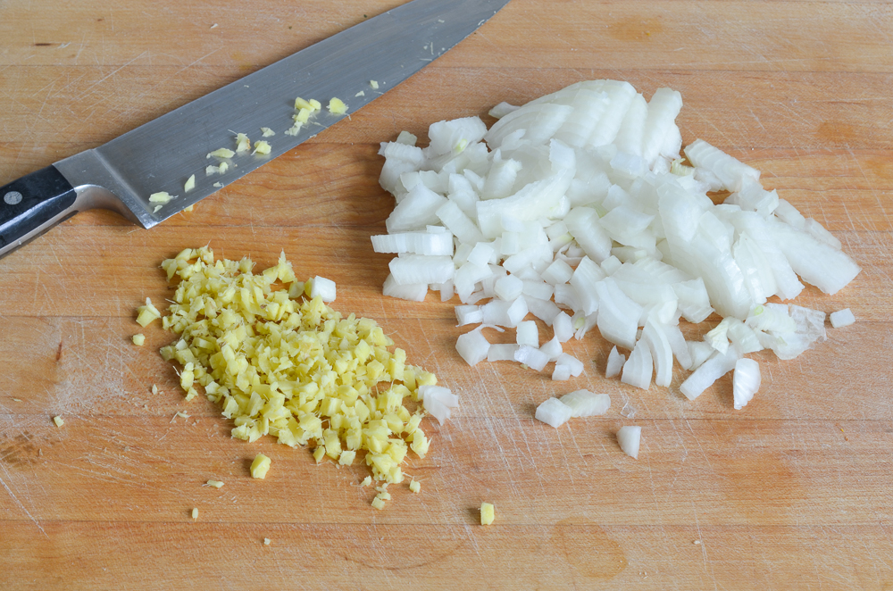chopped ginger and onions on board