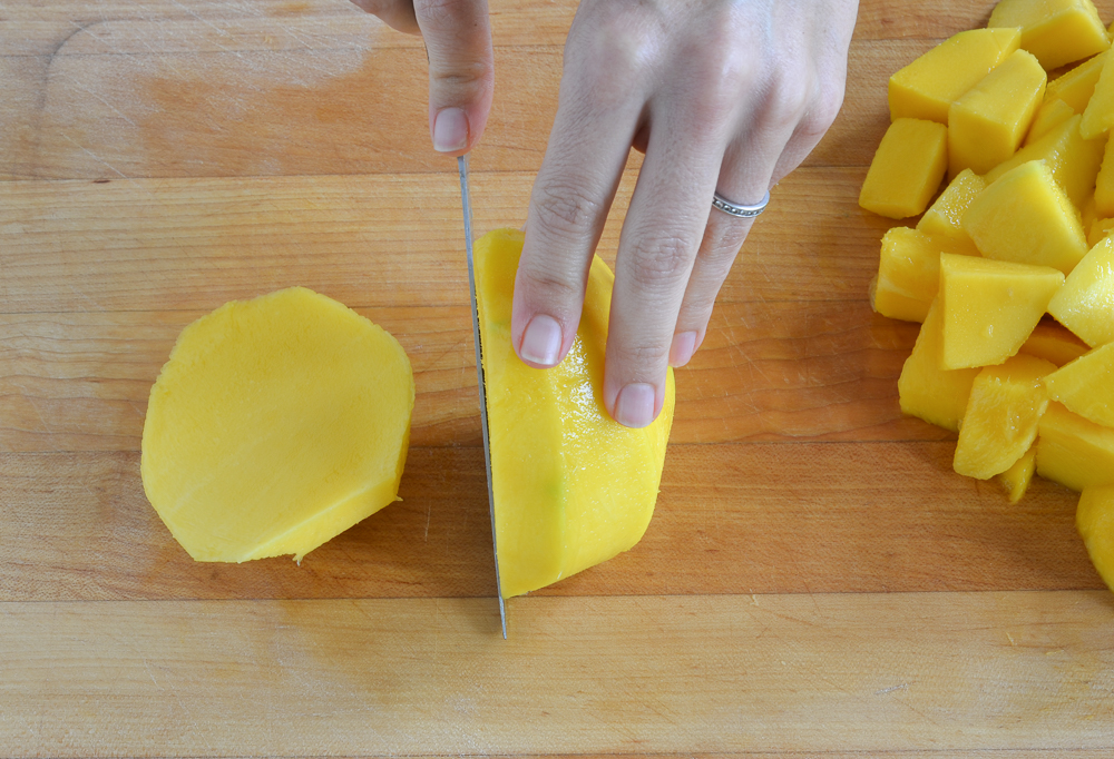 cutting one mango cheek off