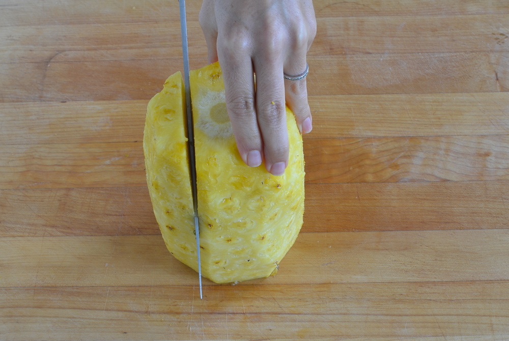slicing pineapple vertically