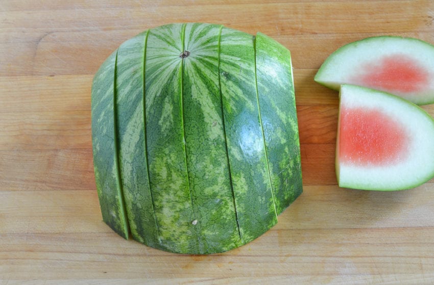 discarding rind from sliced watermelon