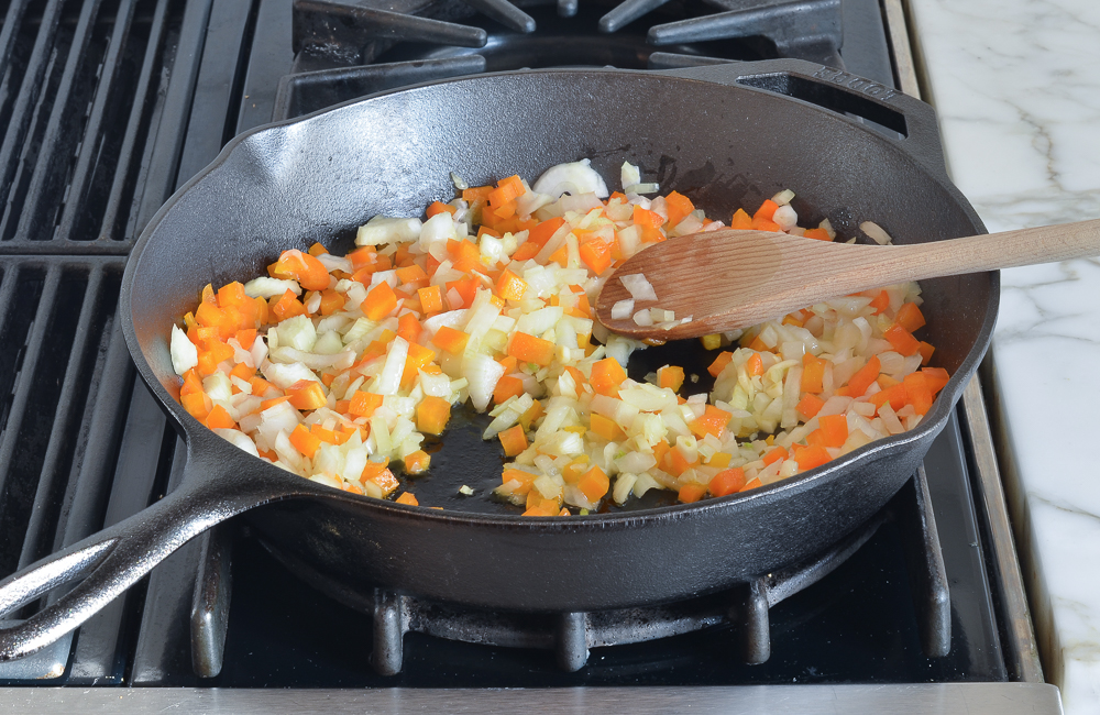 onions, garlic and peppers cooking in skillet