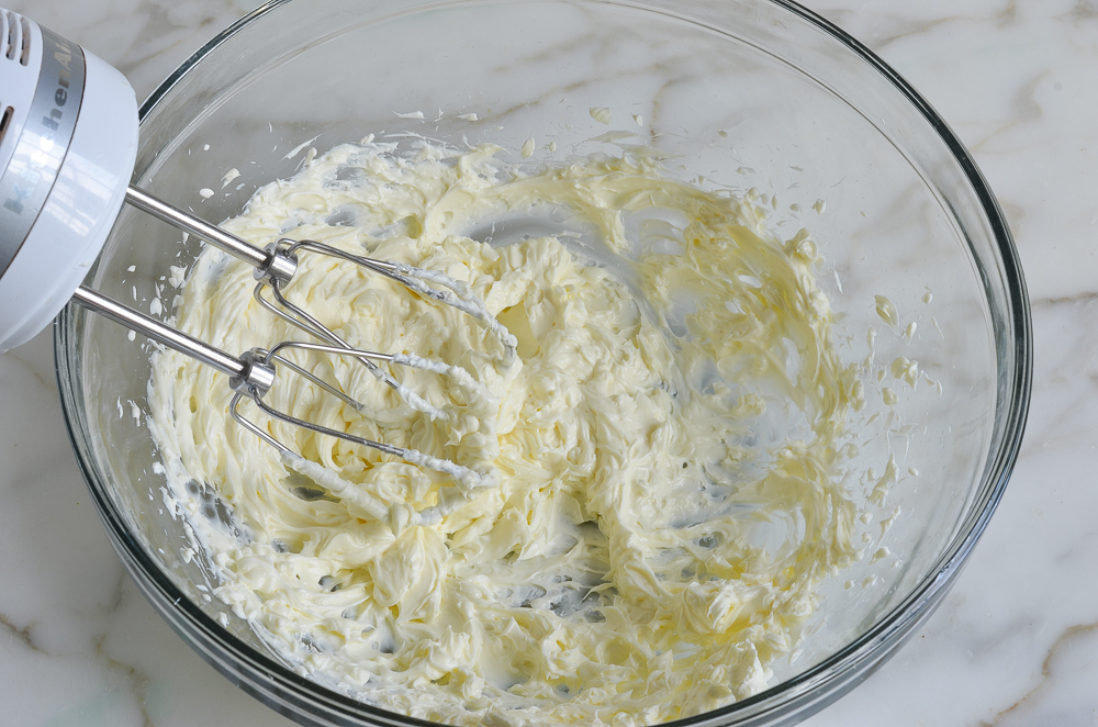 beating cream cheese in mixing bowl