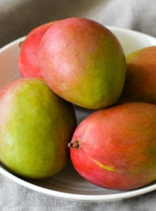 Bowl of whole mangos.