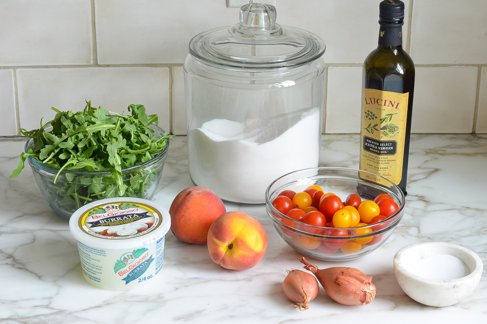 Burrata ingredients including peaches, olive oil, and tomatoes.