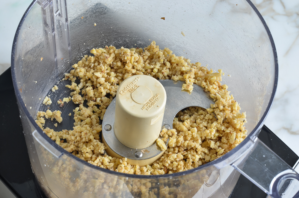 Processed nuts in a food processor.