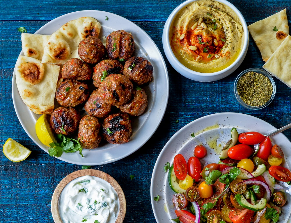 Table set with plates of Middle Eastern food.