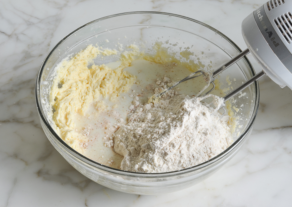 Dry ingredients, milk, and butter mixture in a bowl.