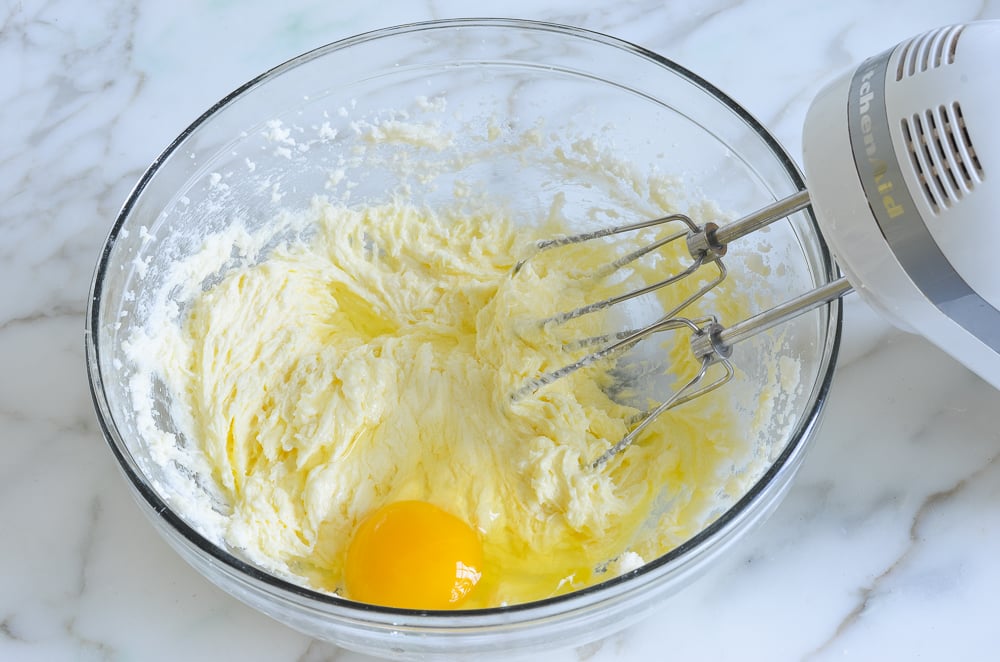 Egg in a bowl with a butter and sugar mixture.