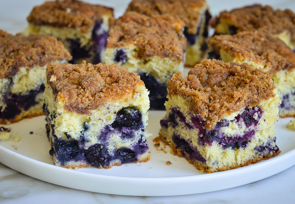 Pieces of blueberry coffee cake on a plate.