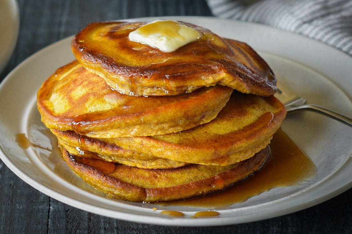 pumpkin pancakes stacked on plate