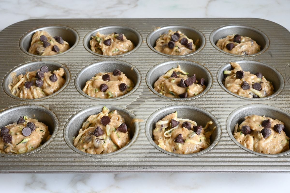 zucchini muffin batter in muffin pan