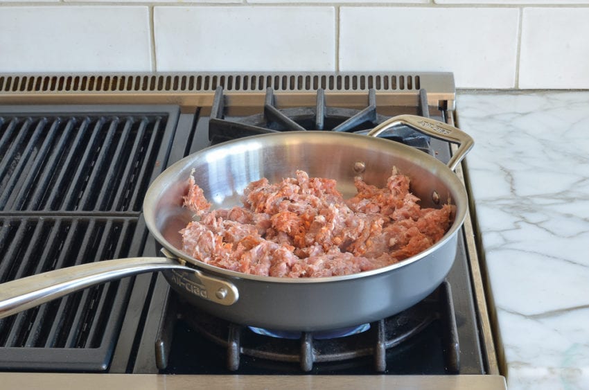 uncooked sausage in skillet