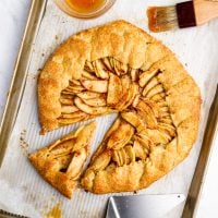 Rustic French apple tart with one slice pulled out.