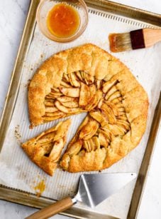 Rustic French apple tart with one slice pulled out.