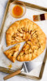Rustic French apple tart with one slice pulled out.