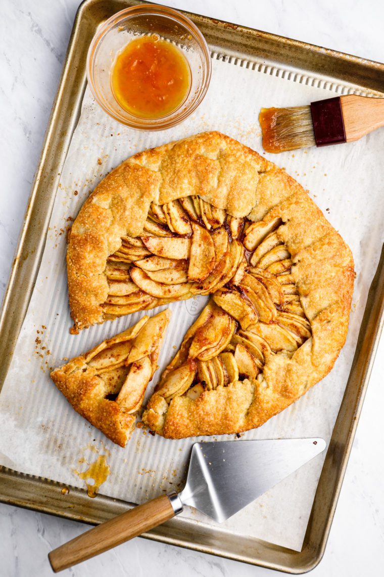 Rustic French apple tart with one slice pulled out.