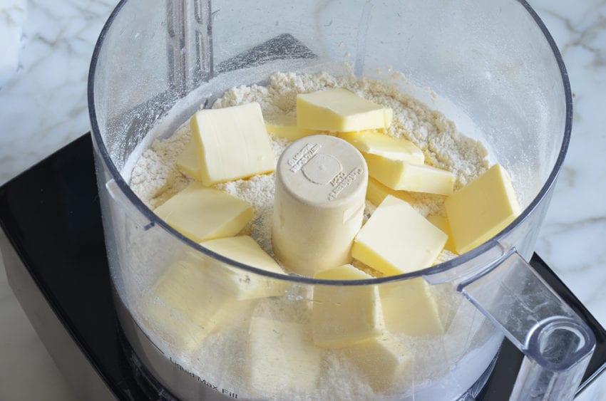 Butter in a food processor with dry ingredients.