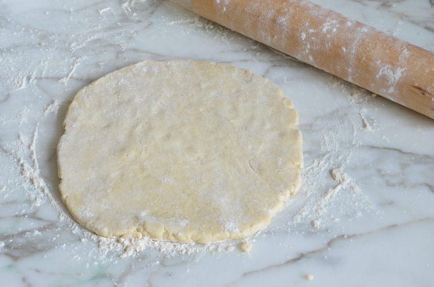 Flattened dough on a countertop.