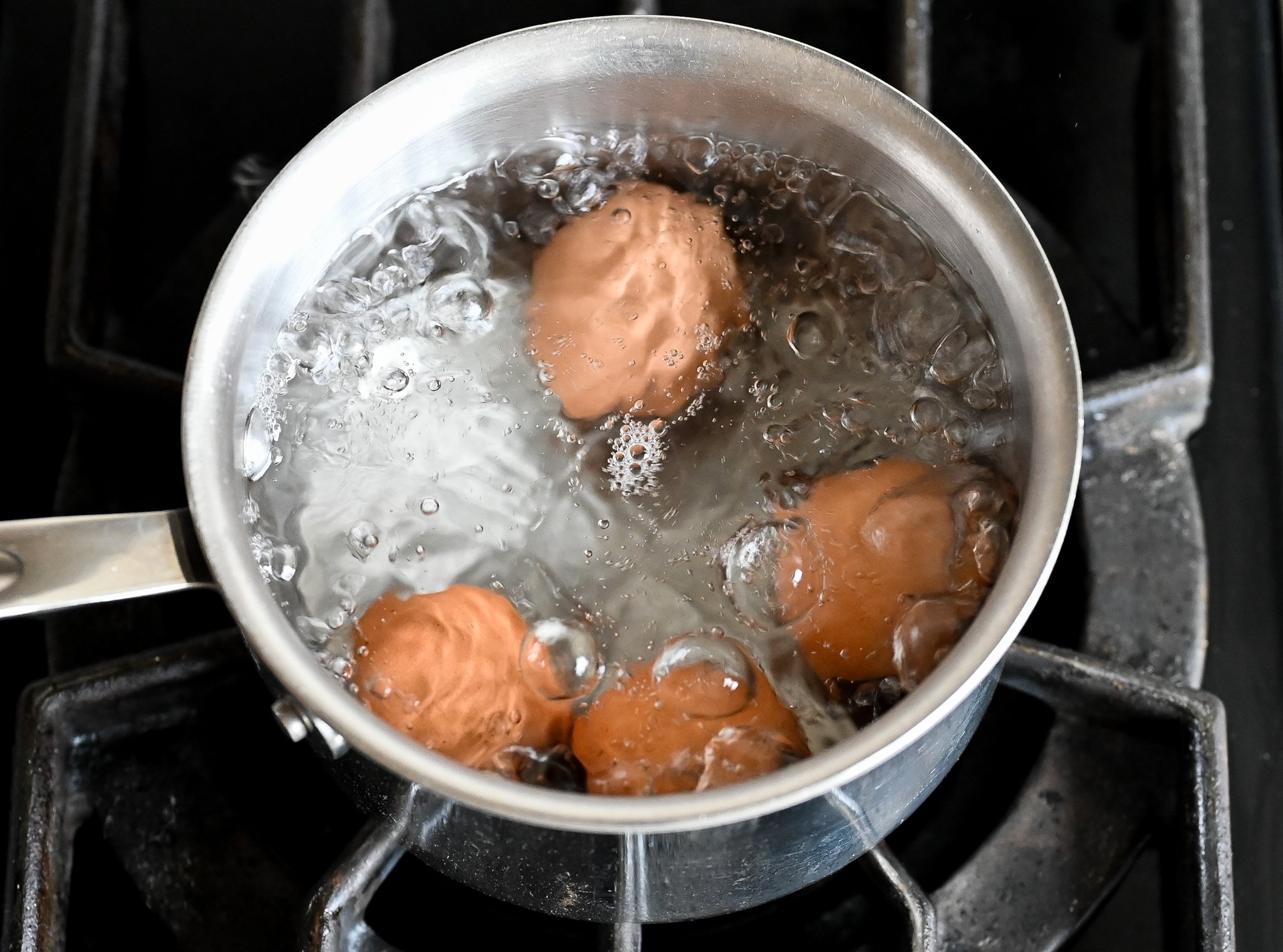 Eggs in a pot of boiling water.