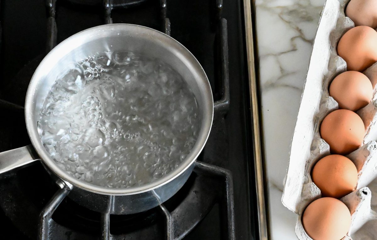 Bringing water to a boil for soft-boiled eggs on a stove. 