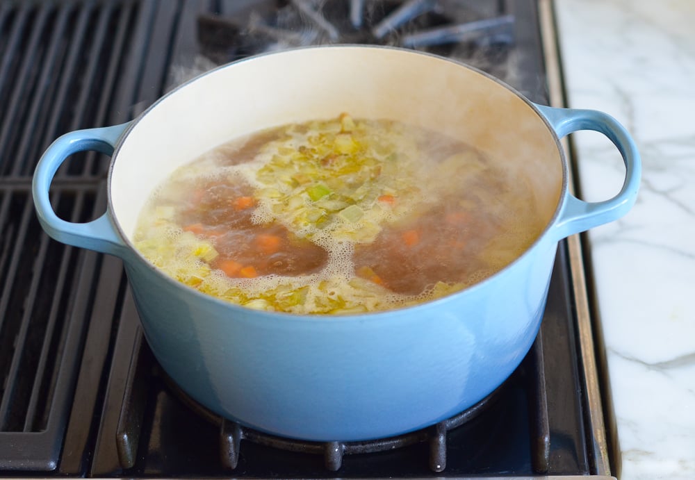 Vegetables boiling in broth.