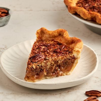 slice of bourbon pecan pie on white plate