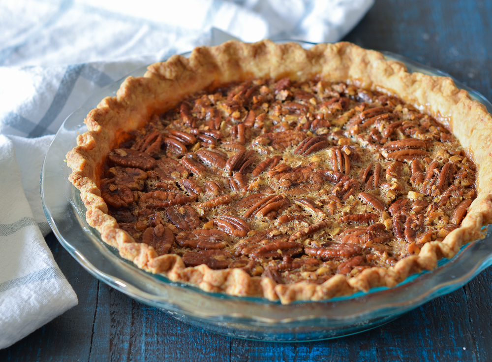 Brown butter and bourbon pecan pie in a glass pie pan.