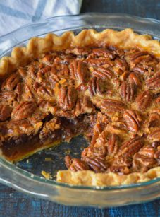 Brown butter and bourbon pecan pie missing a slice.