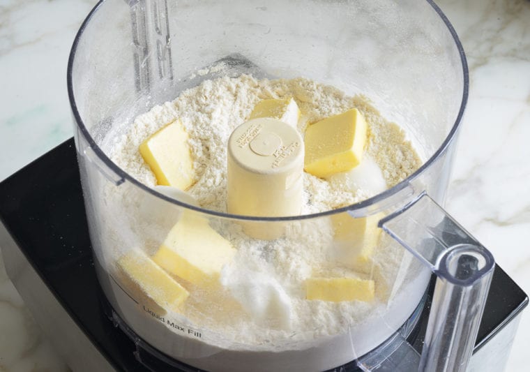 Butter in a food processor with dry ingredients.