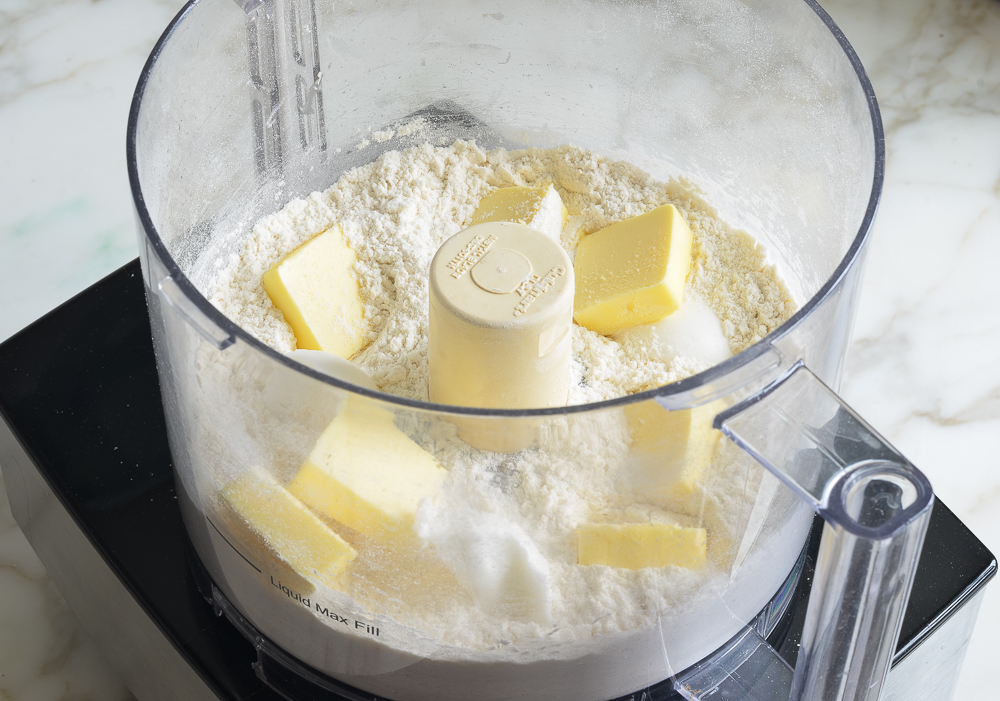 Butter on dry ingredients in a food processor.