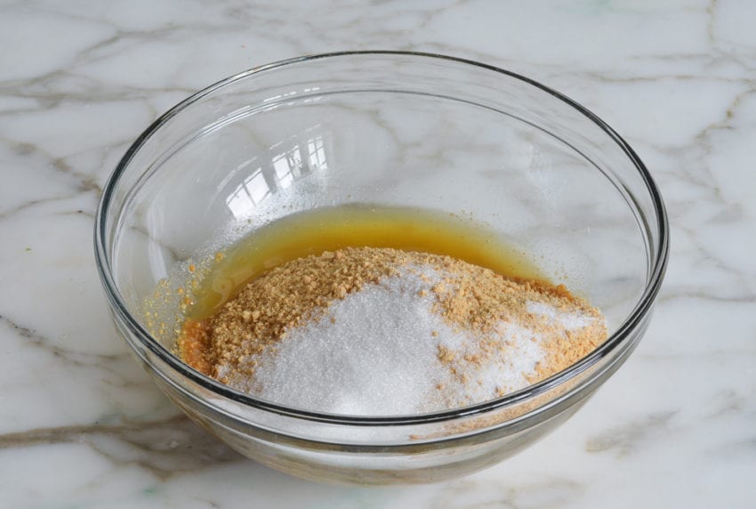 Graham cracker crumbs in a bowl with other ingredients.